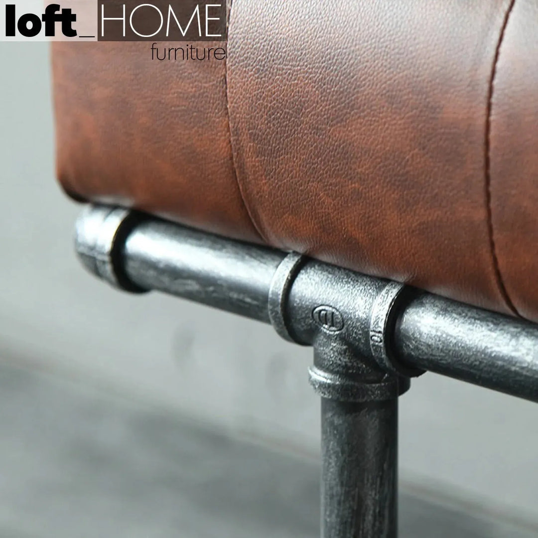 Industrial leather dining bench pipe with context.