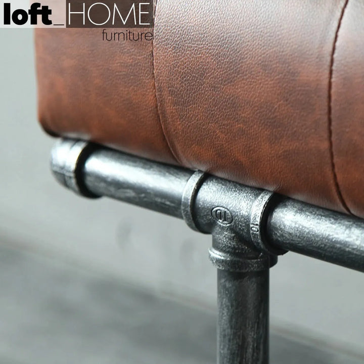 Industrial leather dining bench pipe with context.