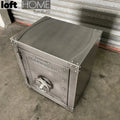 Industrial metal side table hatch wheel in still life.