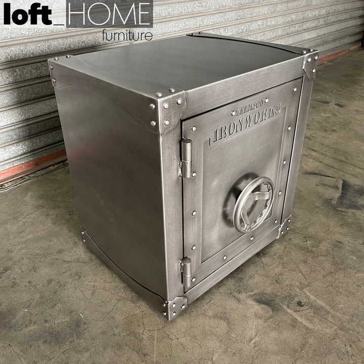 Industrial metal side table hatch wheel in close up details.
