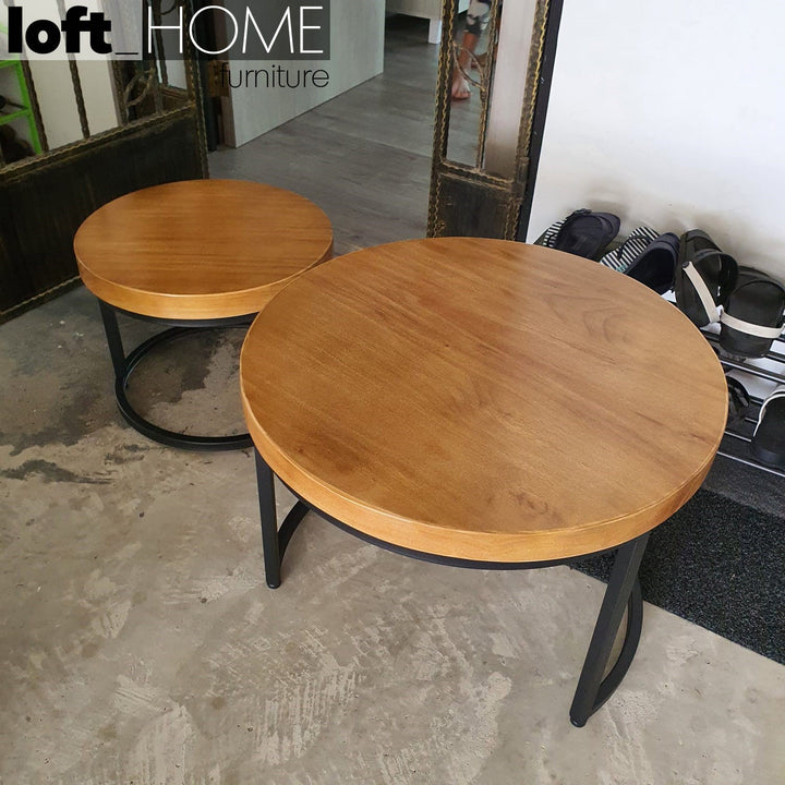 Industrial pine wood round coffee table classic in panoramic view.