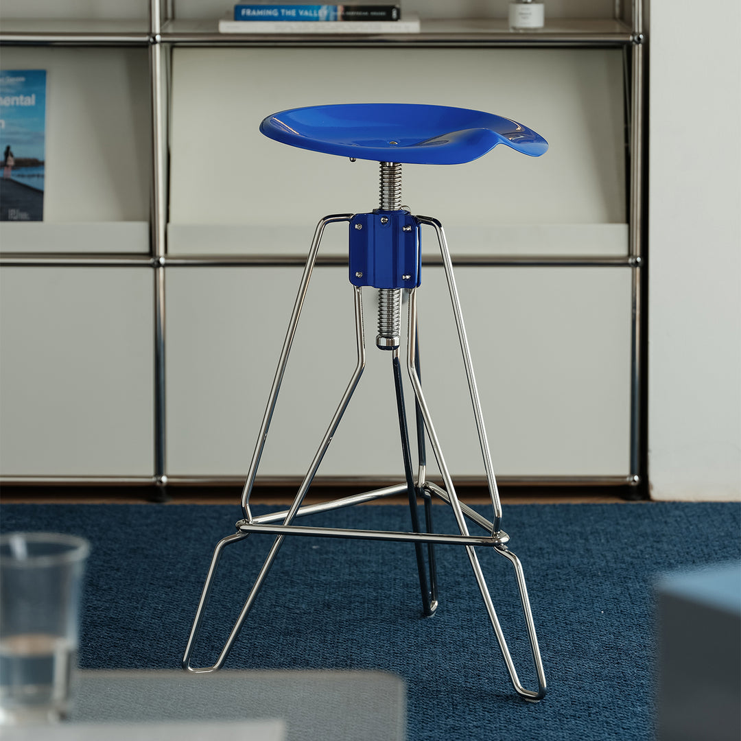Industrial steel height adjustable bar chair spool in still life.