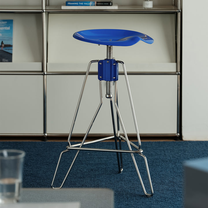Industrial steel height adjustable bar chair spool in still life.