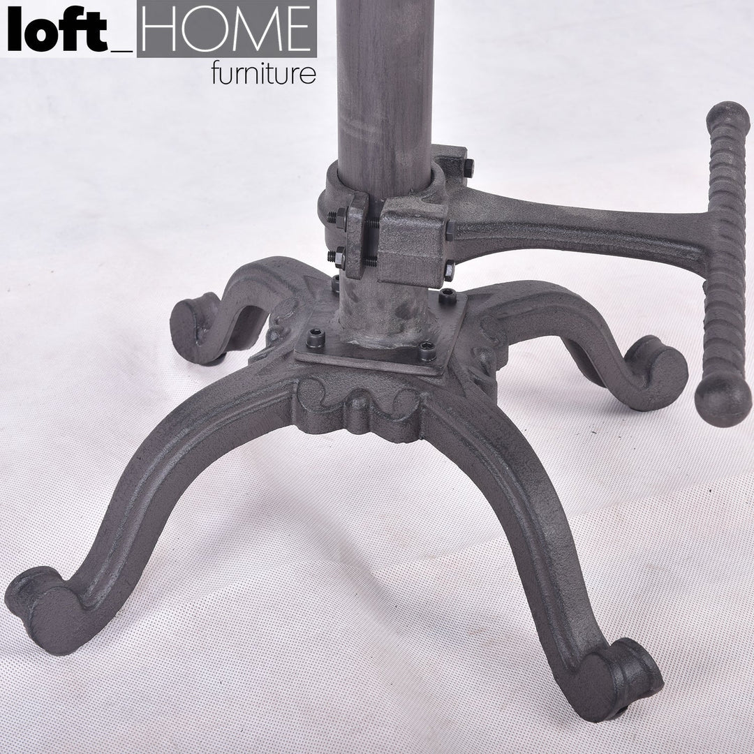 Industrial steel height adjustable stool dewy in still life.