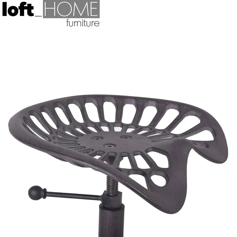 Industrial steel height adjustable stool dewy in panoramic view.