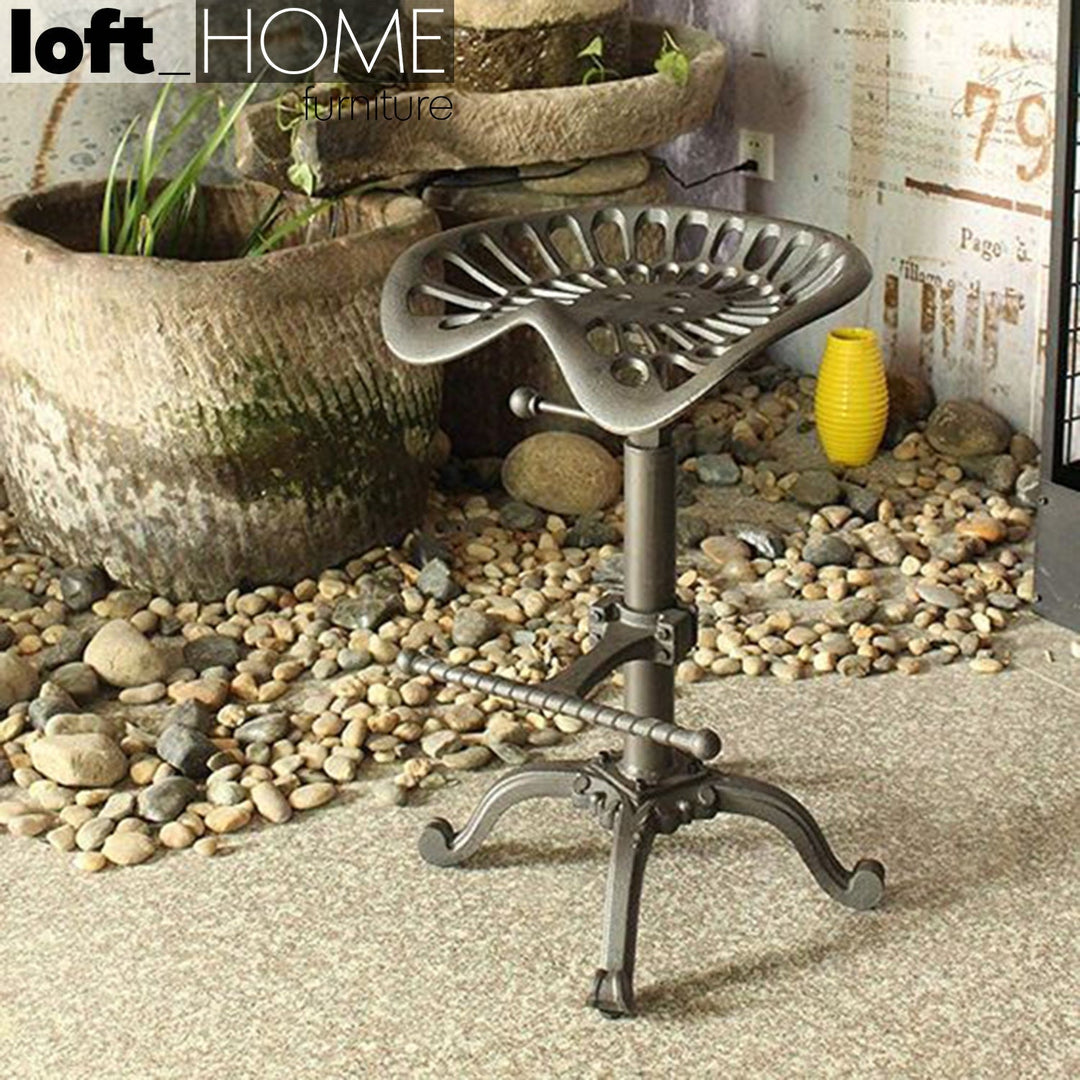 Industrial steel height adjustable stool dewy in close up details.