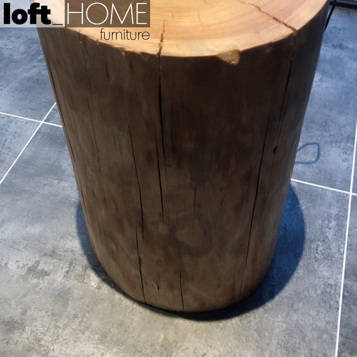 Industrial wood side table stump in close up details.