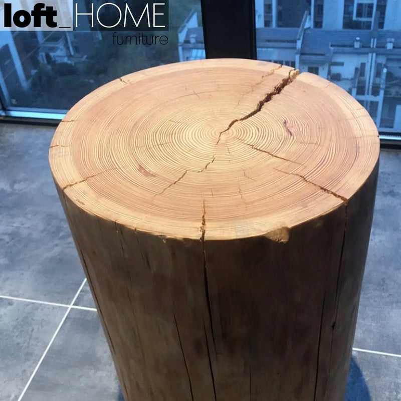 Rustic wood side table stump in panoramic view.