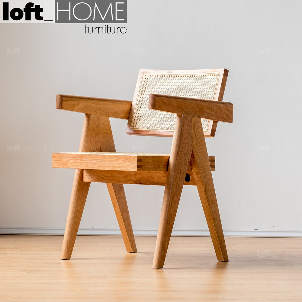 Japandi rattan armrest dining chair jeanneret primary product view.