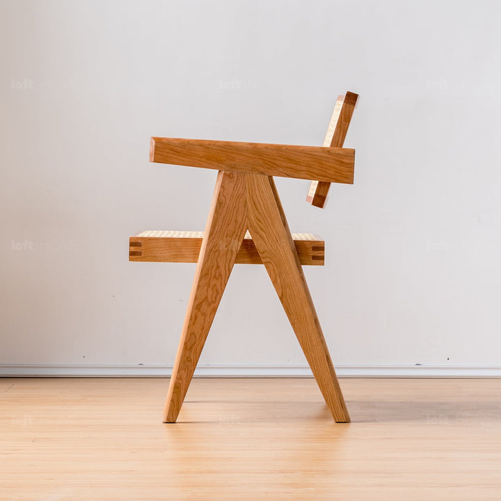 Japandi rattan armrest dining chair jeanneret in still life.