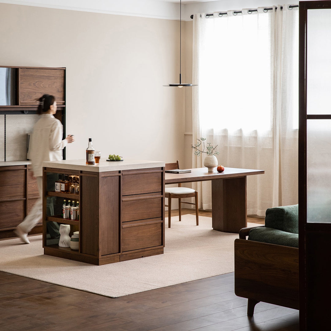 Japandi walnut wood sintered stone island dining table with cabinet axis primary product view.