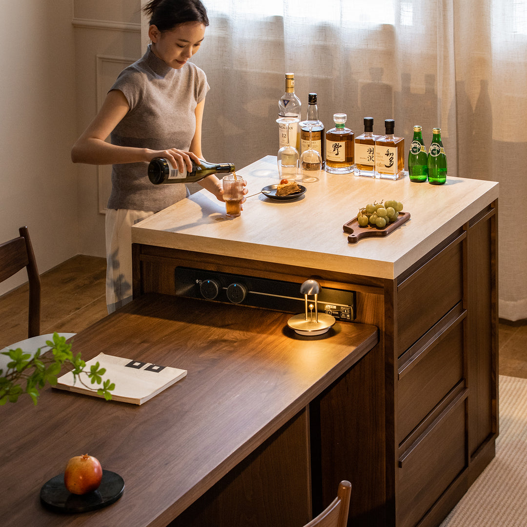 Japandi walnut wood sintered stone island dining table with cabinet axis with context.