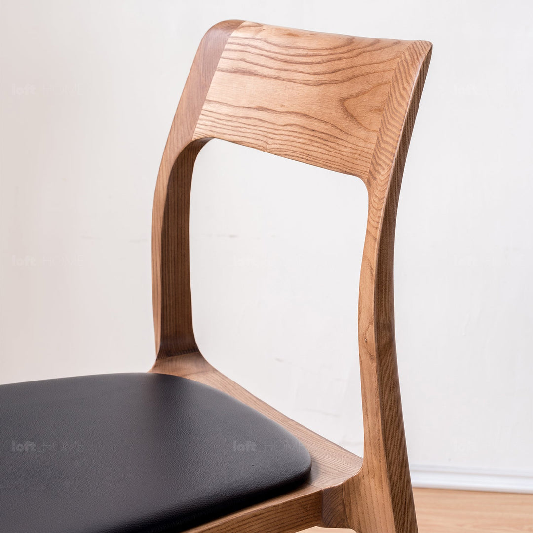 Japandi wood dining chair sleek in close up details.