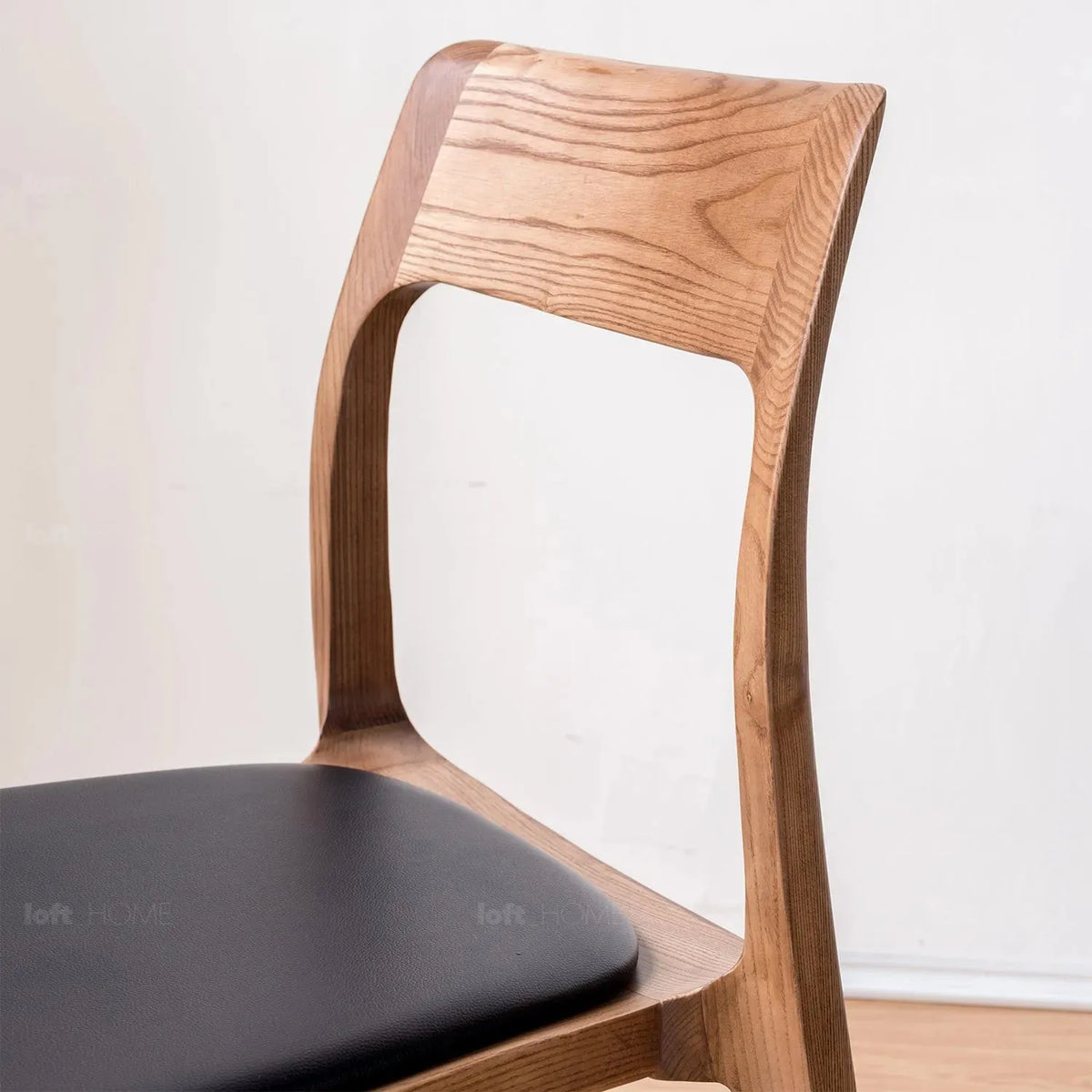 Japandi wood dining chair sleek in close up details.