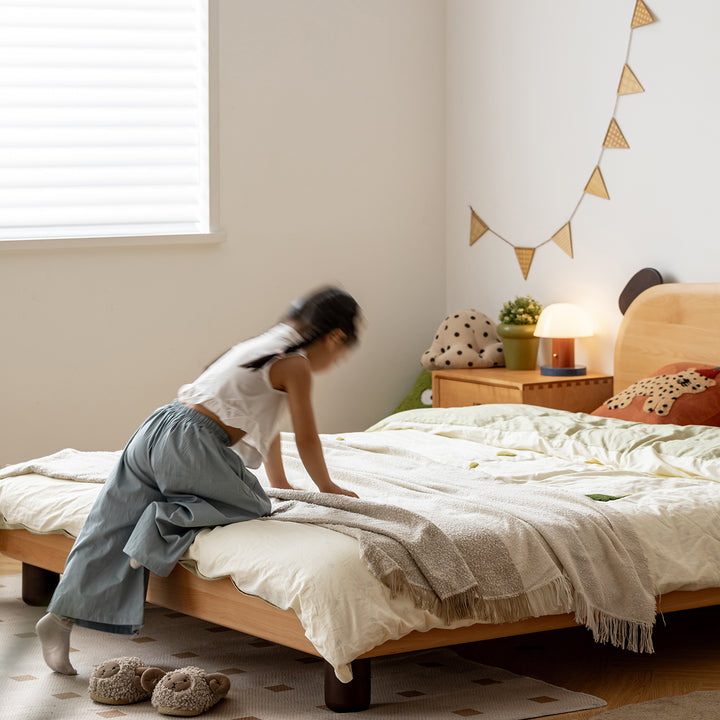 Scandinavian beech wood kids bed teddy with context.