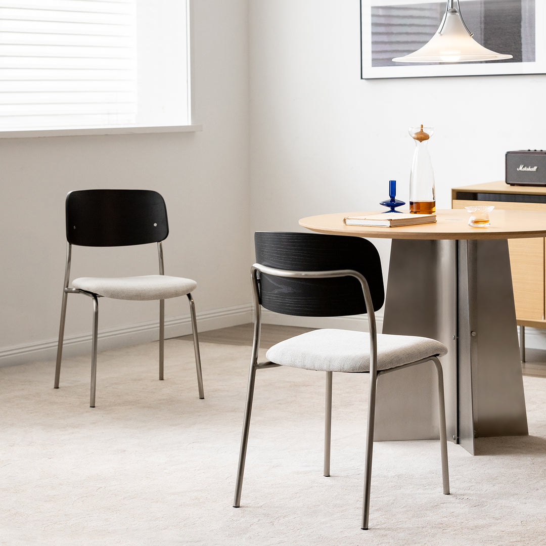 Minimalist ash wood veneer cotton fabric dining chair black aeri in panoramic view.