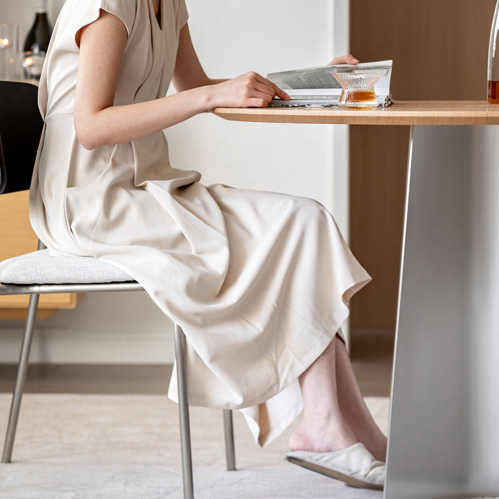 Minimalist ash wood veneer stainless steel round dining table aeri in real life style.