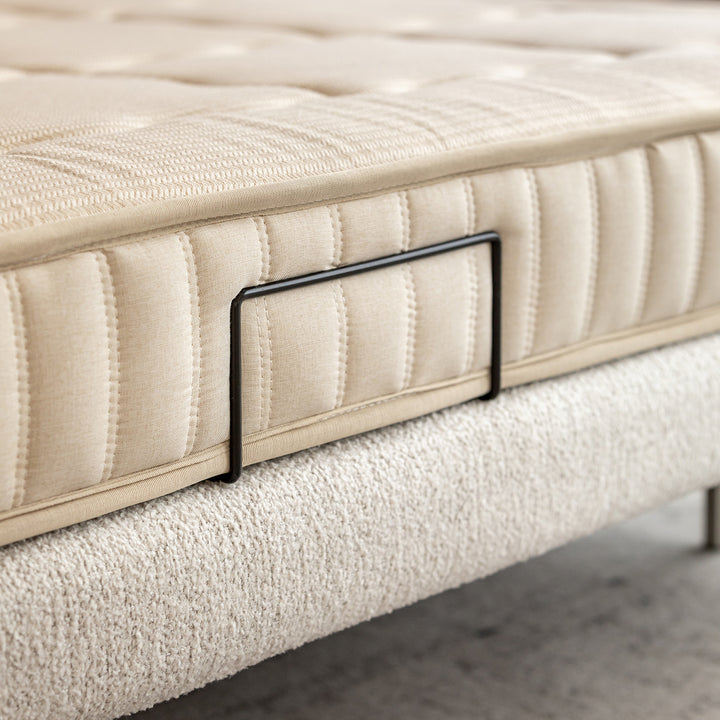 Minimalist boucle fabric bed morn in panoramic view.