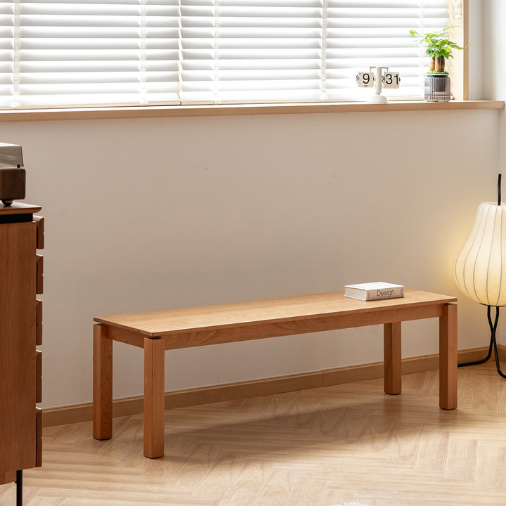 Minimalist cherry wood dining bench coastal in close up details.