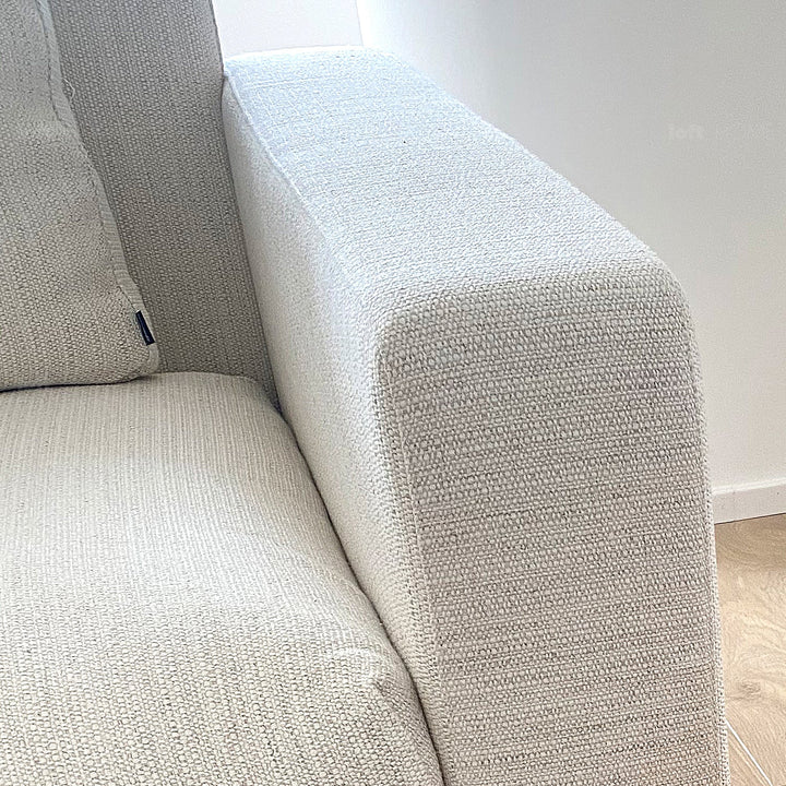 Minimalist fabric 3 seater sofa white in close up details.