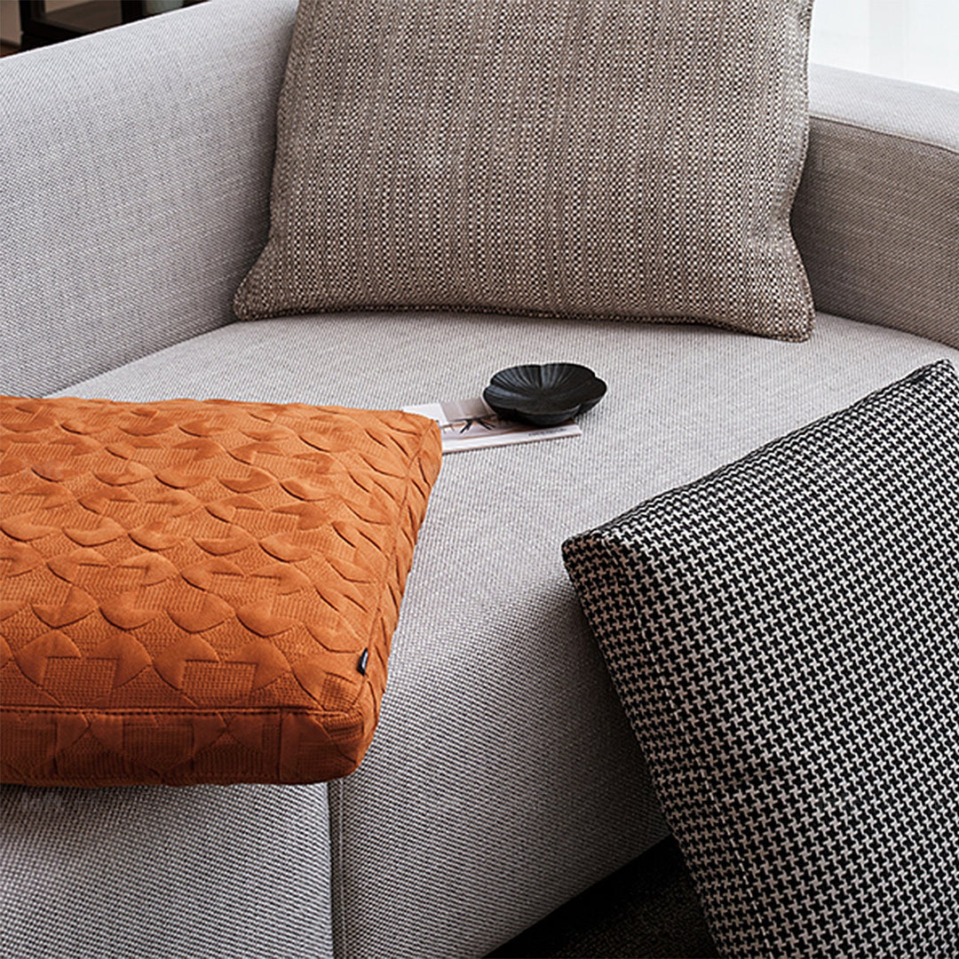Minimalist fabric sofa pillow classic orange with context.
