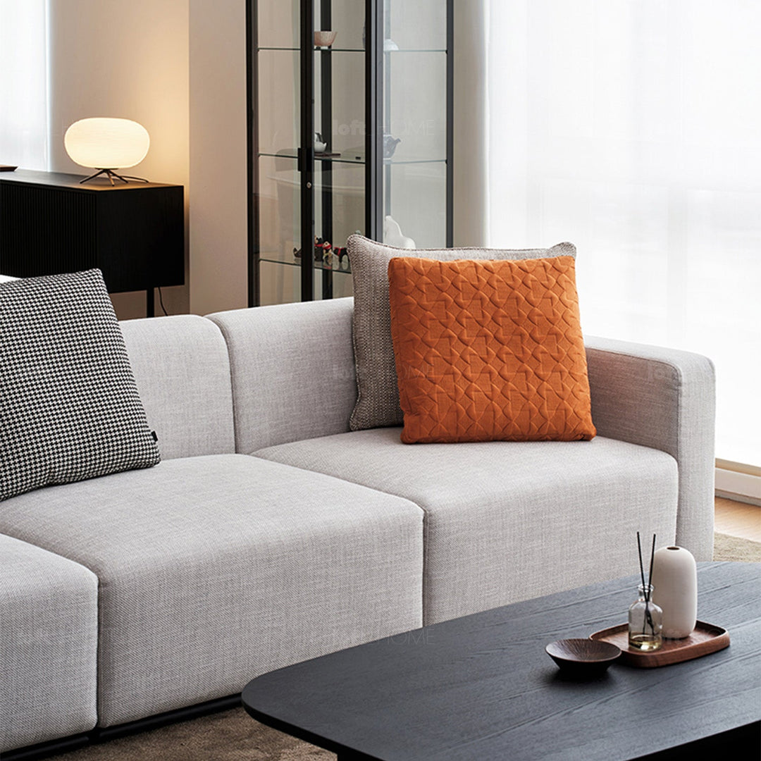 Minimalist fabric sofa pillow classic orange in real life style.