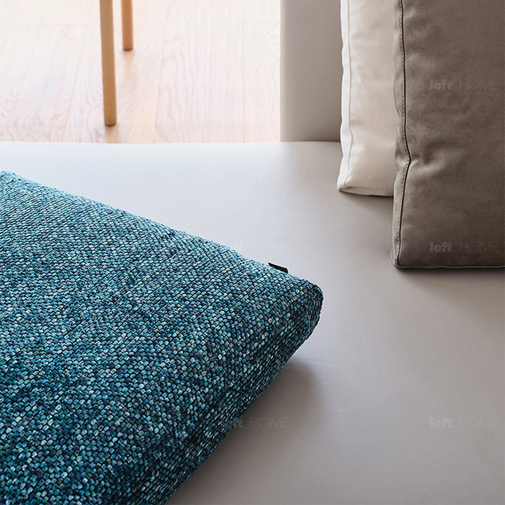 Minimalist fabric sofa pillow winter blue in close up details.