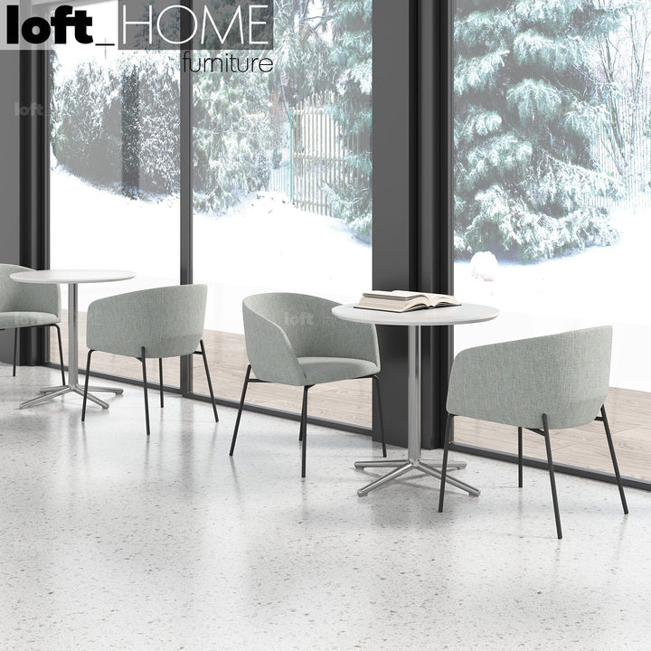 Minimalist metal fabric dining chair slicing primary product view.