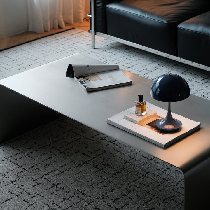Minimalist steel coffee table arc in close up details.