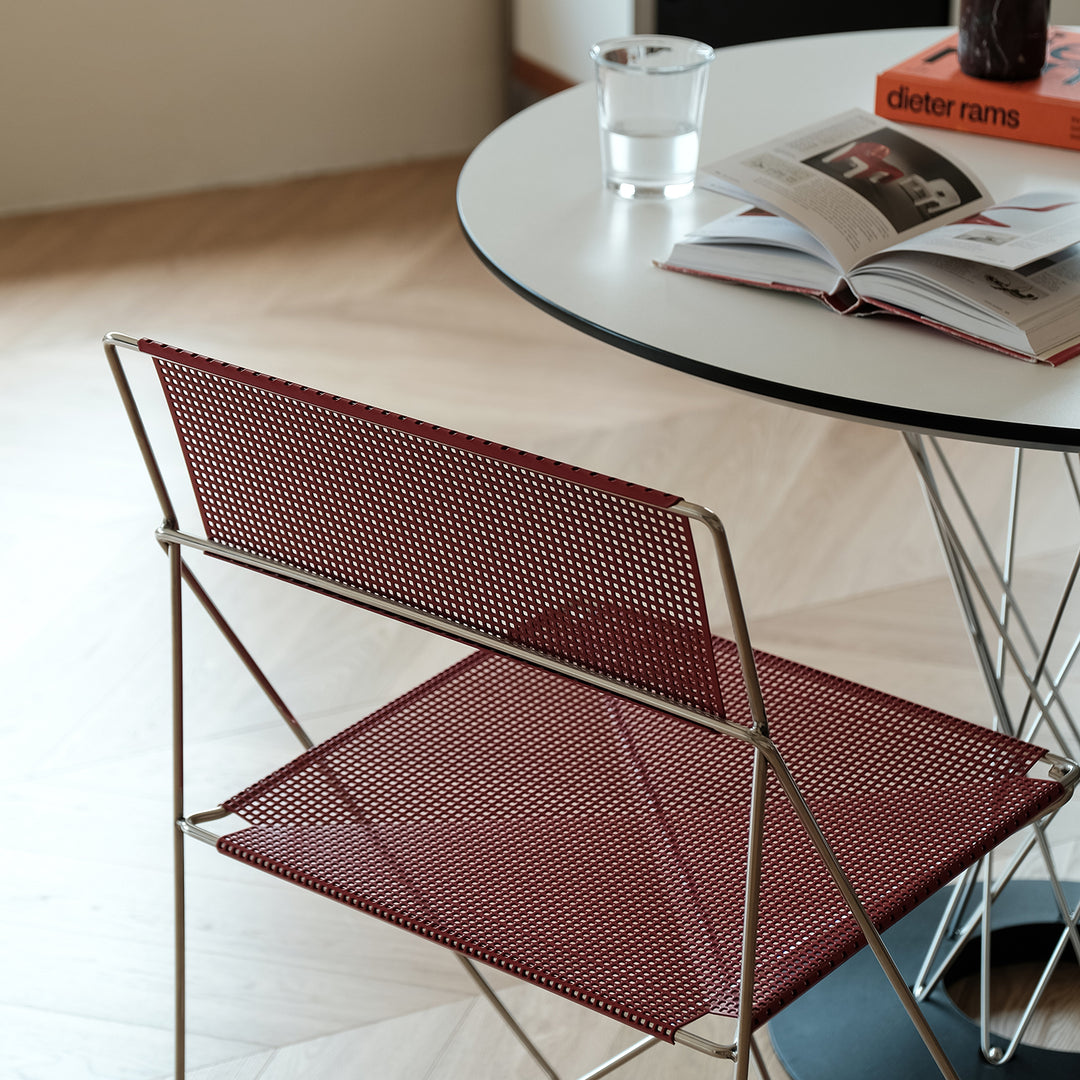 Minimalist steel dining chair x-line in still life.