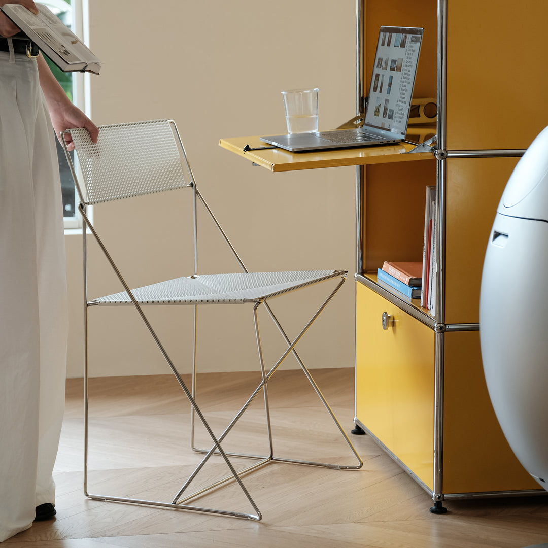 Minimalist steel dining chair x-line with context.