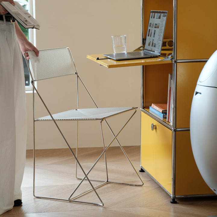 Minimalist steel dining chair x-line with context.