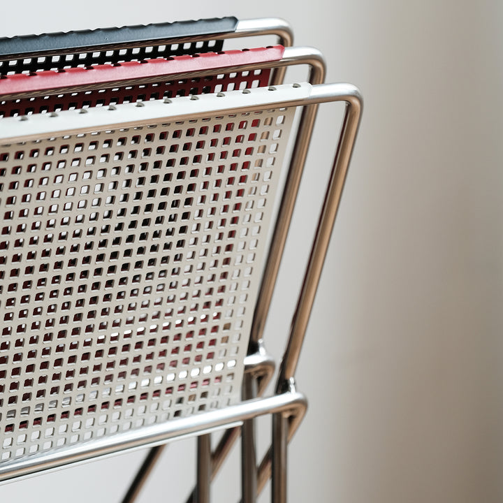 Minimalist steel dining chair x-line in close up details.