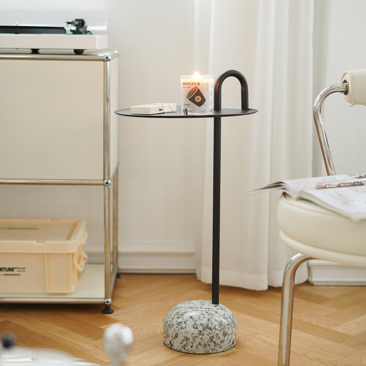 Minimalist steel marble side table loop with context.