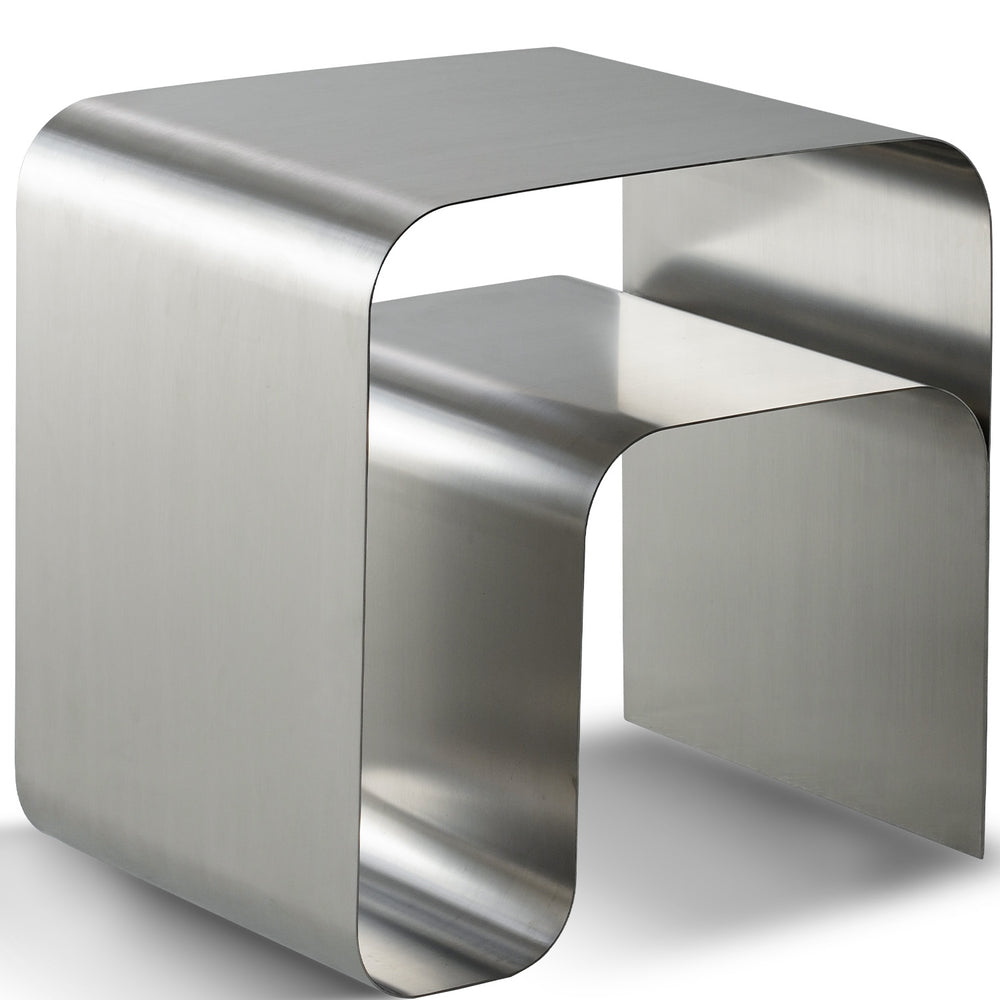 Minimalist steel side table arc in white background.