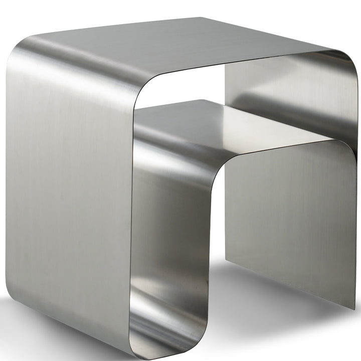 Minimalist steel side table arc in white background.
