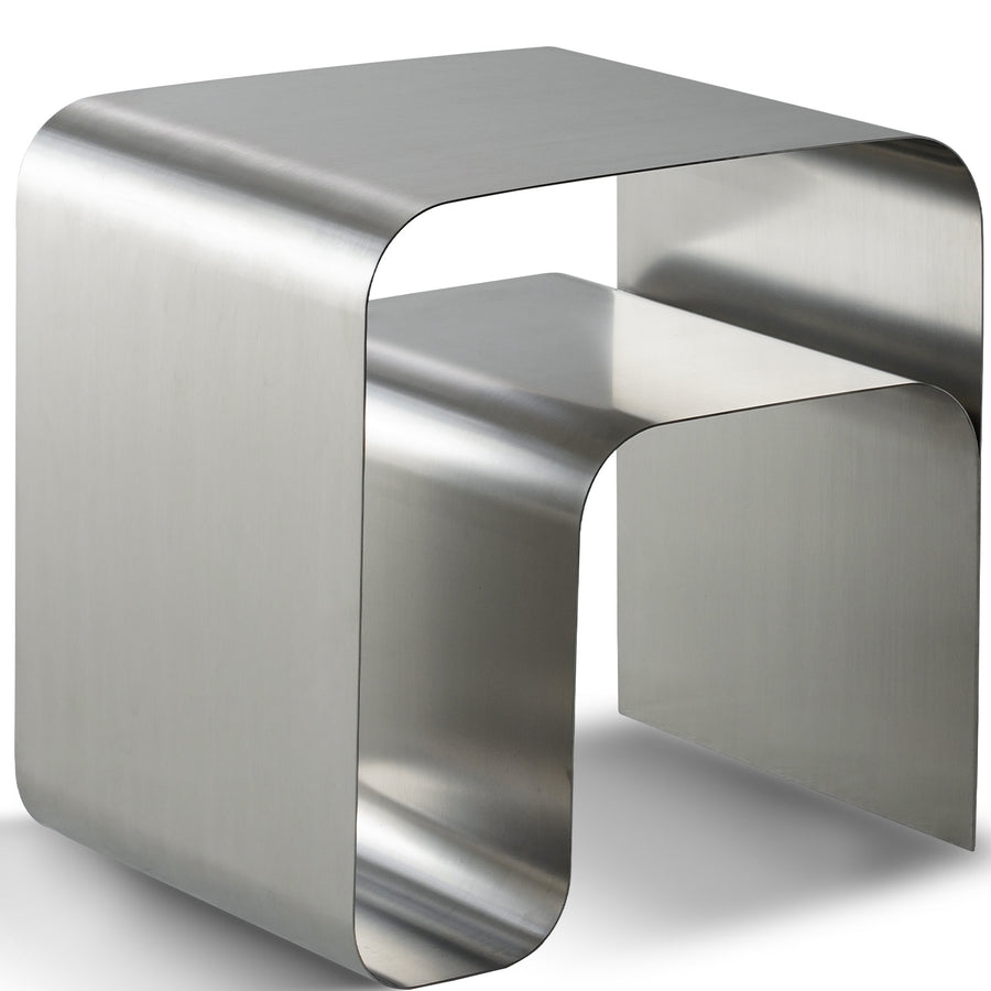 Minimalist steel side table arc in white background.
