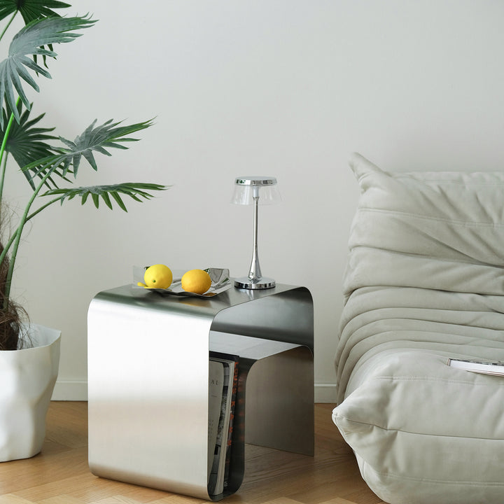 Minimalist steel side table arc with context.