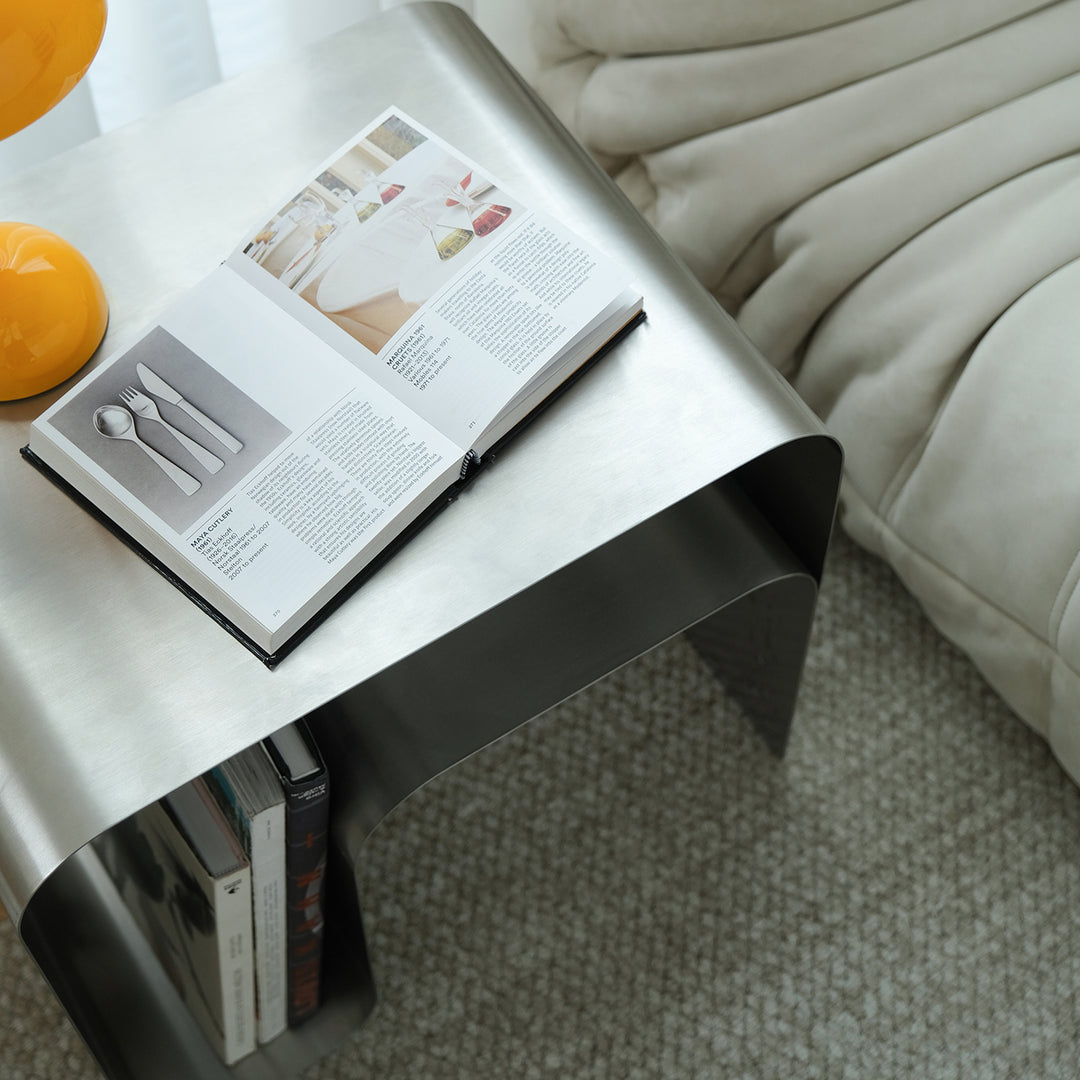 Minimalist steel side table arc in details.
