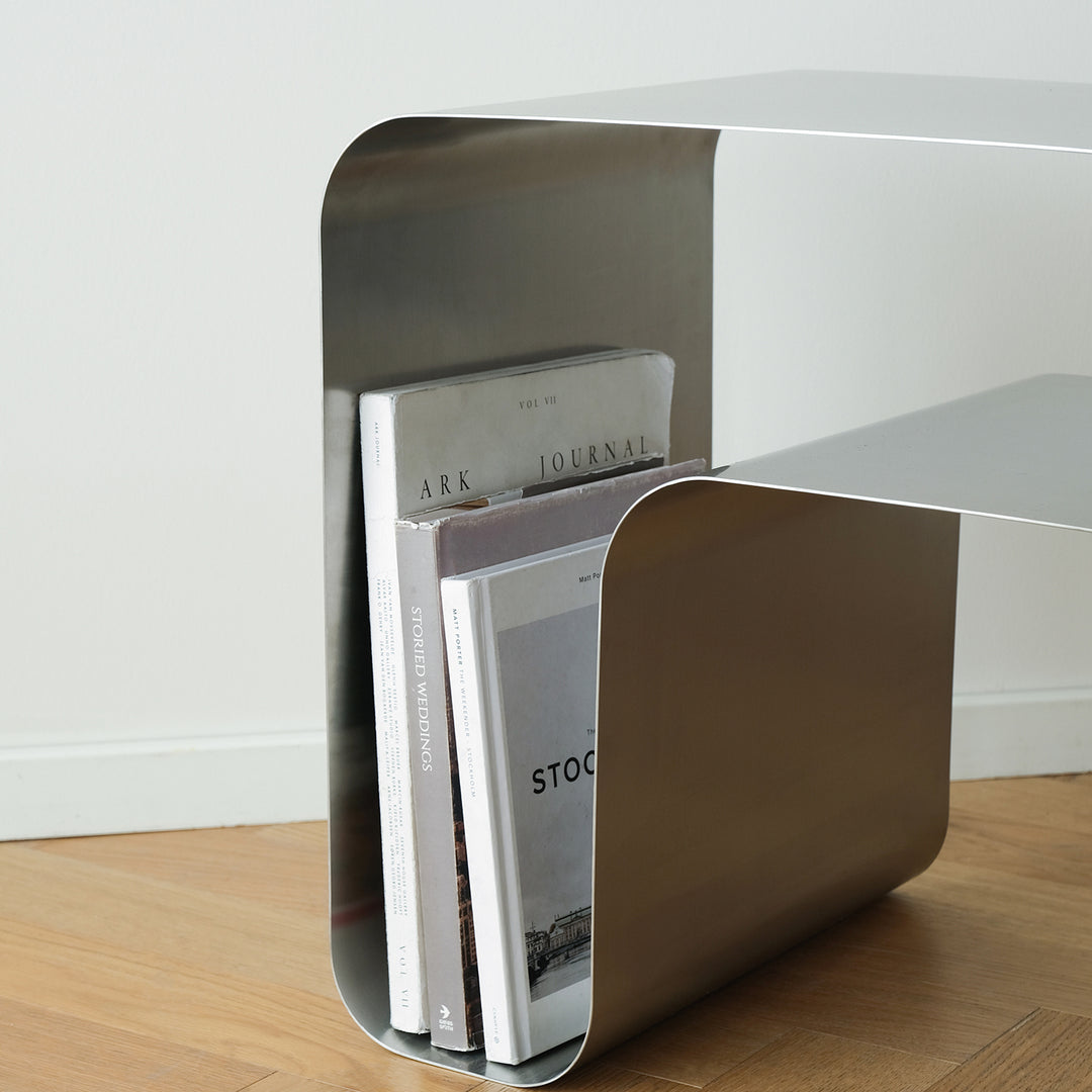 Minimalist steel side table arc in close up details.