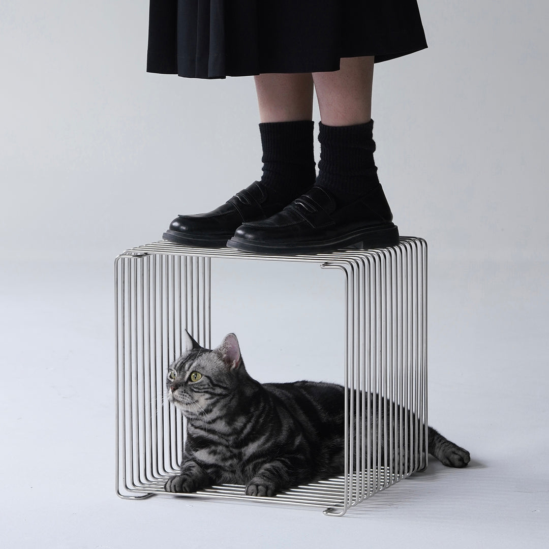 Minimalist steel side table panton wire with context.