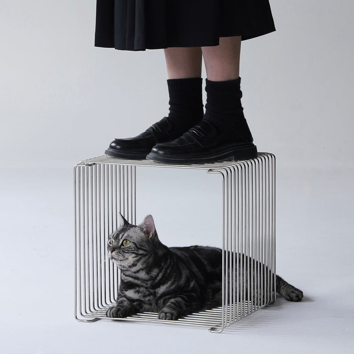 Minimalist steel side table panton wire with context.