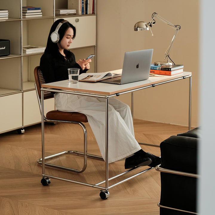 Minimalist steel wheeled study table usm in panoramic view.