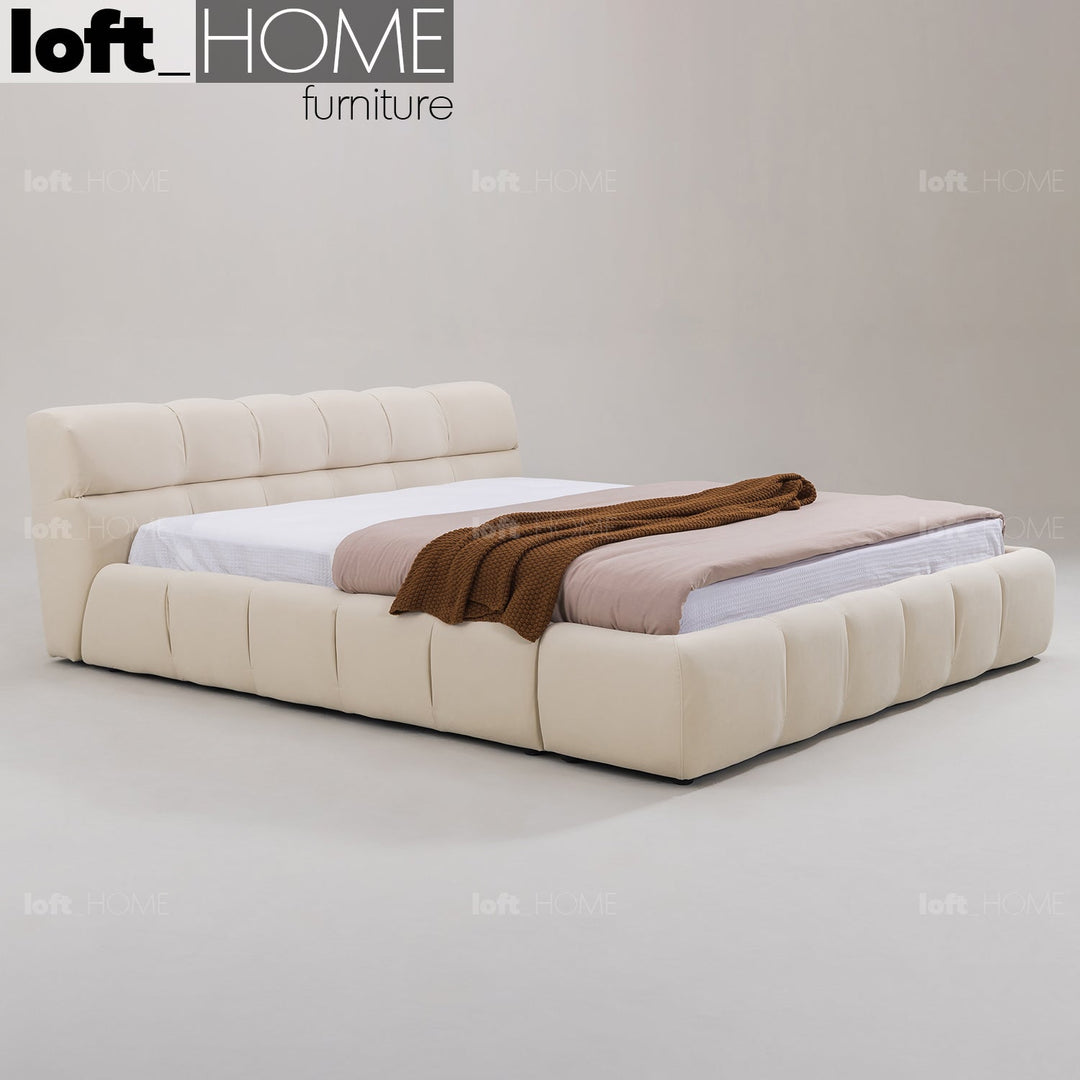 Minimalist suede fabric bed tufty with context.
