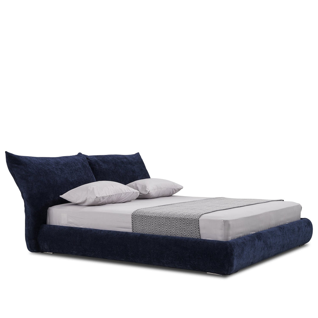 Minimalist velvet fabric bed standard in white background.