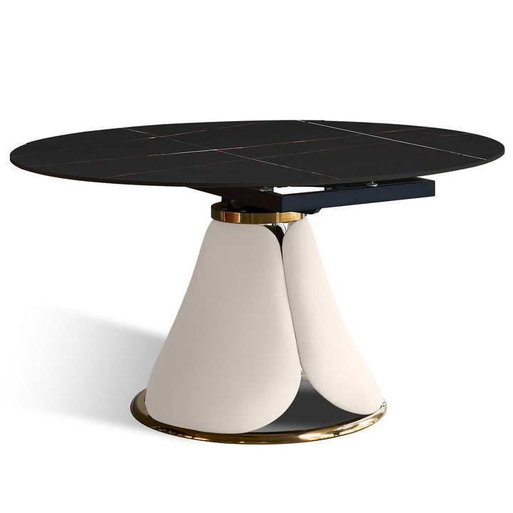 Modern extendable sintered stone round dining table petal in still life.