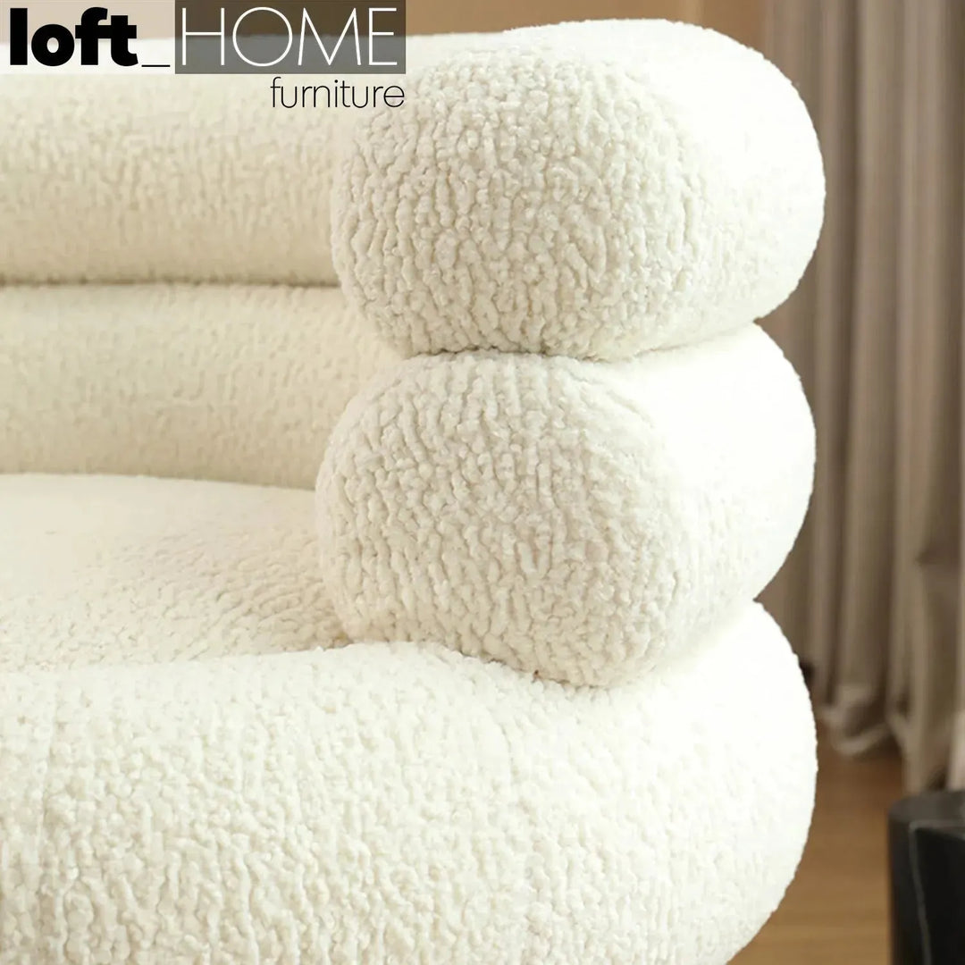 Cream fabric 1 seater sofa sheepskin with context.