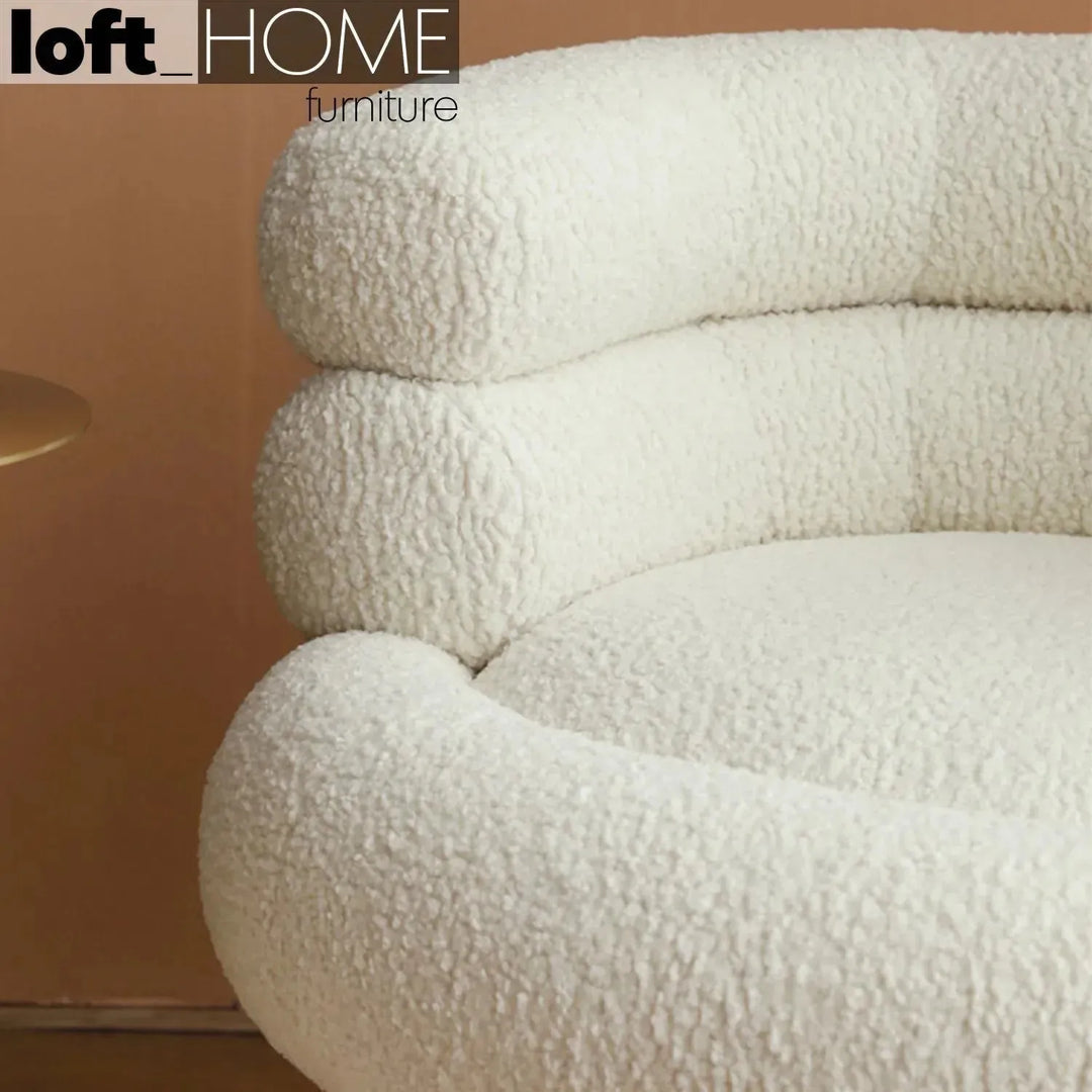 Cream fabric 1 seater sofa sheepskin in panoramic view.