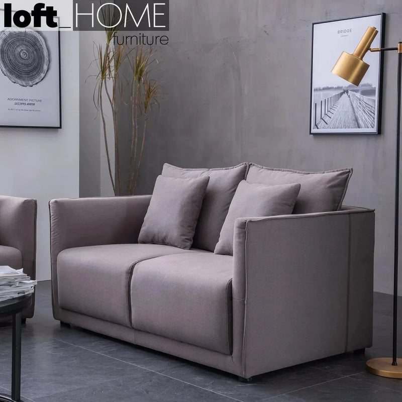 Modern fabric 2 seater sofa adam with context.