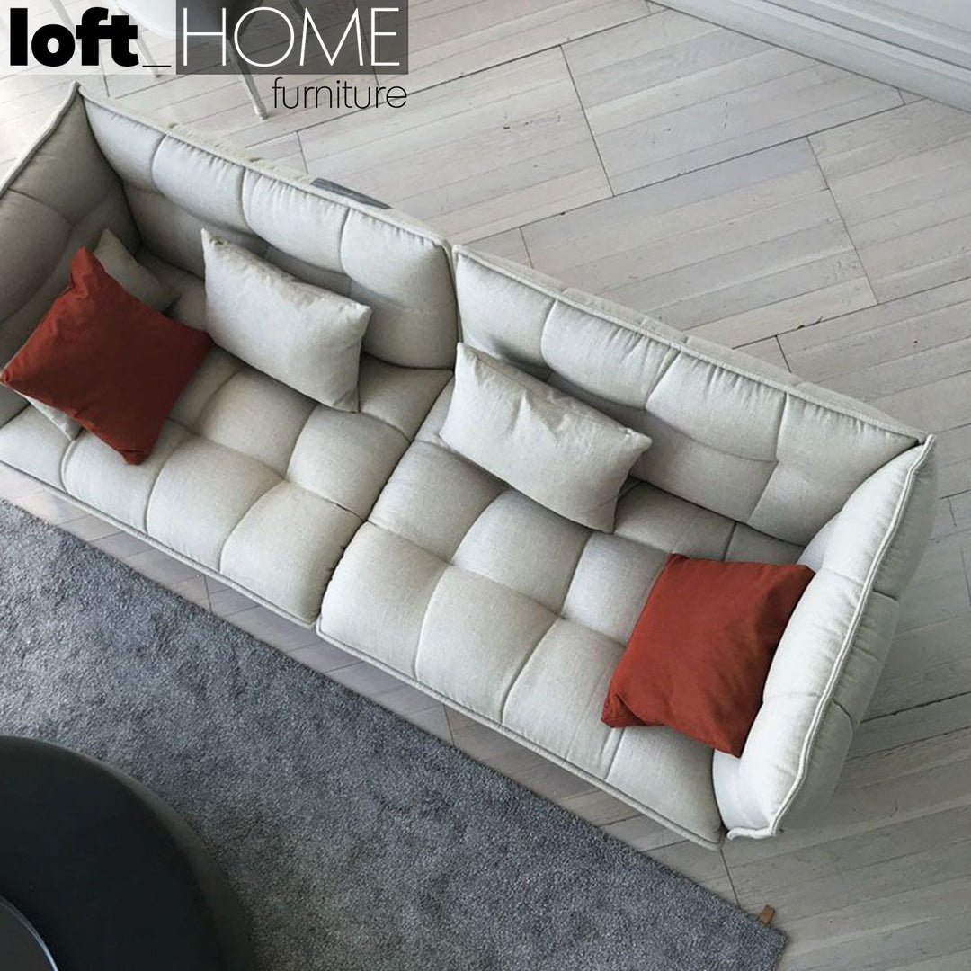 Modern fabric 3 seater sofa husk in panoramic view.